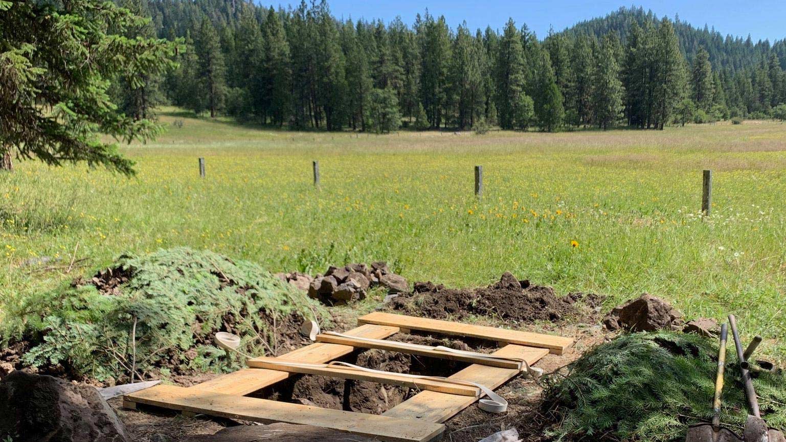 prepared grave site by meadow